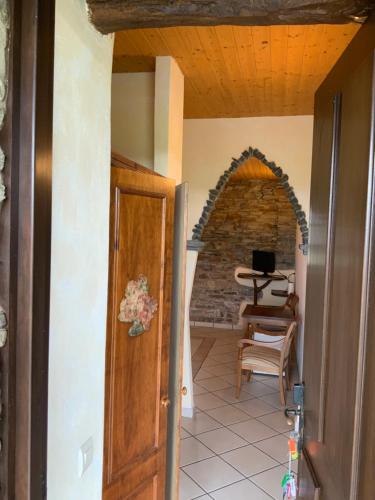 a room with a door and a chair and a table at Hotel y Apartamentos Penarronda Playa in Castropol