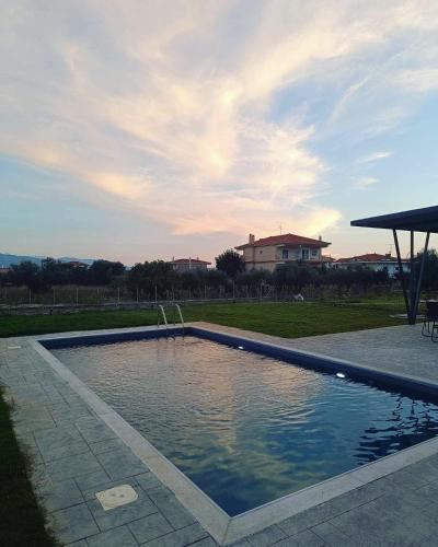 a swimming pool in a yard with a house in the background at Nostos Luxury Villas with Private Pool in Nafpaktos in Nafpaktos