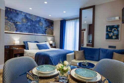 a hotel room with a bed and two tables and chairs at Lord Morgan & Exclusive Design Cihangir in Istanbul