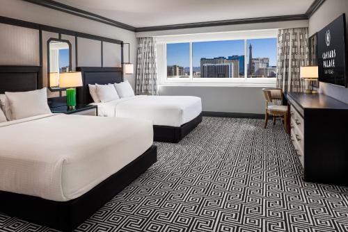 a hotel room with two beds and a window at Caesars Palace Hotel & Casino in Las Vegas