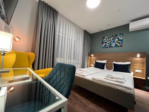 una stanza d'albergo con un letto e una sedia di Stay Vilnius Hotel a Vilnius