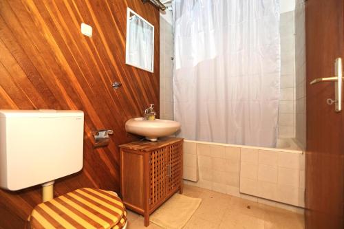 a bathroom with a sink and a toilet and a shower at Apartment Plaza in Hvar