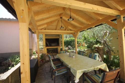 a wooden pavilion with a table and chairs on a patio at Apartment for 4 persons, by the sea and with beautiful view in Kali