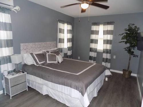 a bedroom with a bed and a ceiling fan at Fishing Retreat C in Pensacola