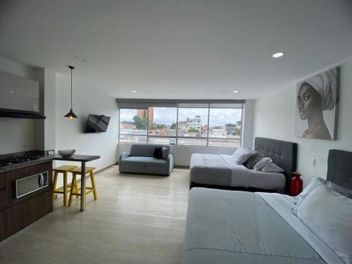 a large living room with a bed and a couch at Spacio30 in Bogotá