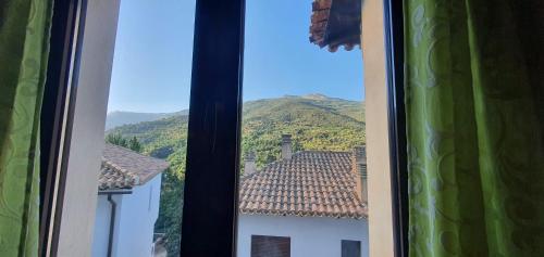 a window with a view of a mountain at Balcon del Calar 27, Guejar Sierra in Güéjar-Sierra