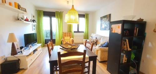 a living room with a table and chairs and a couch at Balcon del Calar 27, Guejar Sierra in Güéjar-Sierra