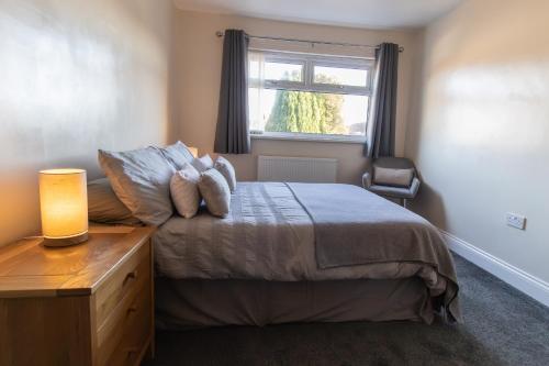 a bedroom with a bed with a dresser and a window at Free Parking 3 Double Bedroom Sunderland House 10 mins drive to Nissan Ideal for Long Term Contractor etc Stays - see our Dwellcome Home Ltd site for assurance in Pallion
