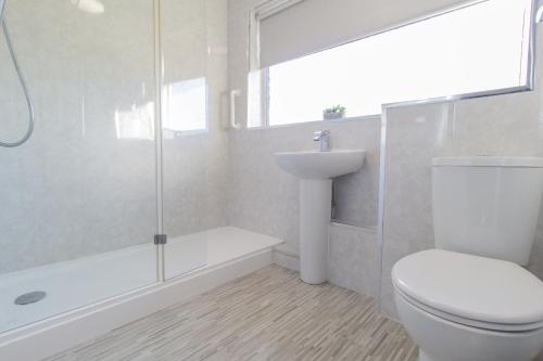 a bathroom with a toilet and a shower and a sink at Dwellcome Home Ltd 3 Bedroom Sunderland House - see our site for assurance in Pallion