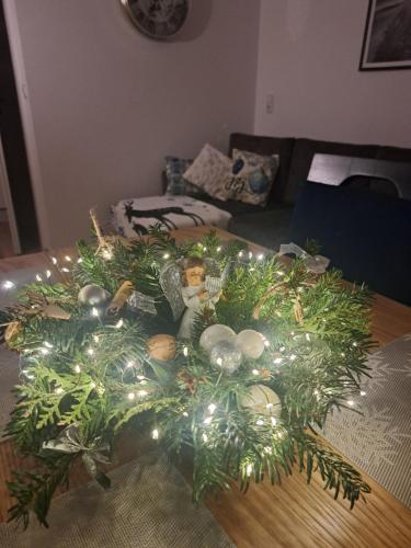 a christmas wreath with lights on a table at SOLEK Apartamenty i pokoje gościnne in Mielno