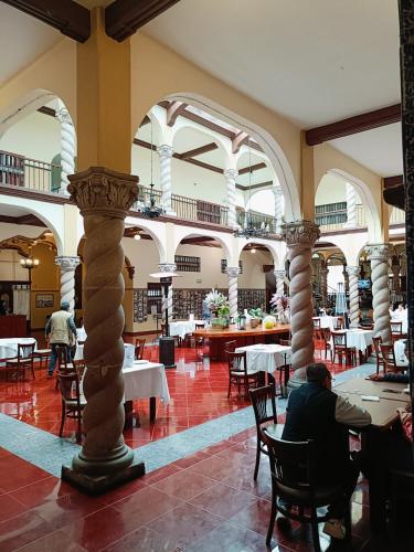 a person sitting at a table in a restaurant at HOTEL VIRREYNAL in Teziutlán