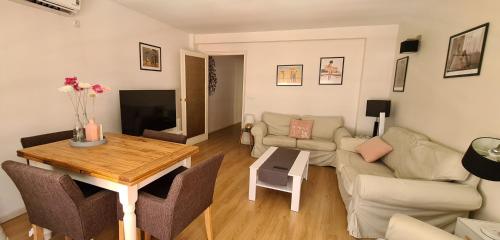 a living room with a table and a couch at Old town - Beach apartment in Benidorm