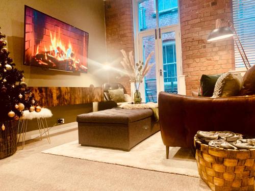 a living room with a fireplace and a christmas tree at The Fifth Quarters, Grade II Listed Apartment, The Lace Market, NG1, City Centre, Nottingham, Sleeps 4 in Nottingham