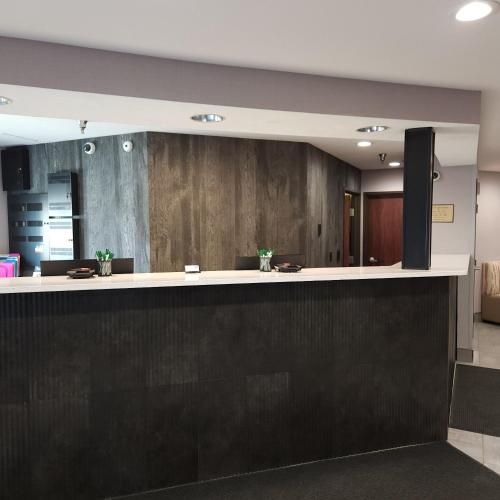 an office lobby with a black and white reception counter at Kelly Inn Billings in Billings