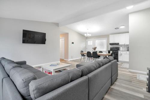 a living room with a gray couch and a table at Relax and Play in Akron