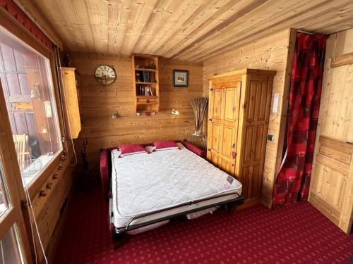 une chambre avec un lit dans une pièce en bois dans l'établissement Belle Plagne - Skis aux pieds - Pierre de Soleil, à La Plagne Tarentaise