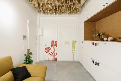 a living room with a couch and a chandelier at tèmporas Design Rooms in Cagliari