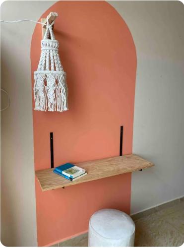 a wall with a shelf with a chandelier on it at Studio Aurora - Recife in Recife