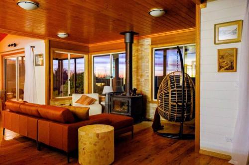 a living room with a couch and a fireplace at Nunyara - Mountain Views, Rural, Kangaroos, Birds in Newnes Junction