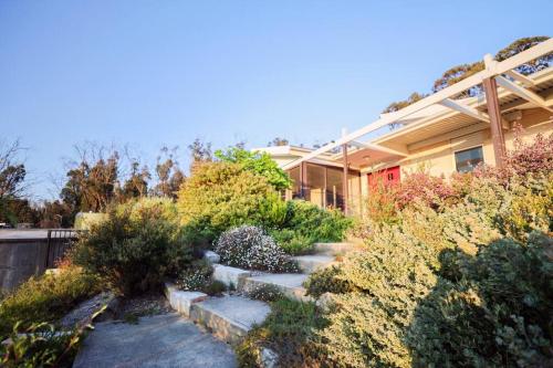 a house with a garden in front of it at Nunyara - Mountain Views, Rural, Kangaroos, Birds in Newnes Junction