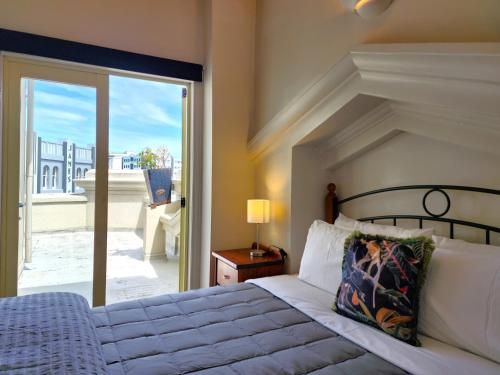 a bedroom with a bed and a sliding glass door at U Suites on Manners in Wellington