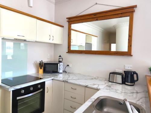 a kitchen with a sink and a microwave at U Suites on Manners in Wellington