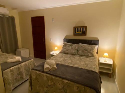 Cama o camas de una habitación en Pousada Canoa dos Anjos suítes