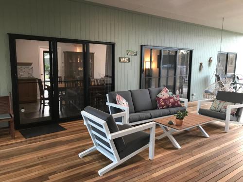 a living room with a couch and a table at Cherry Mango Guesthouse in Apple Tree Creek