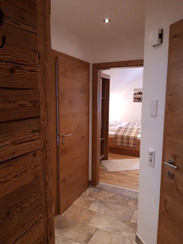 a hallway with wooden doors and a bedroom at Gasthaus Brandlwirt in Saalfelden am Steinernen Meer