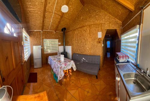 an overhead view of a living room with a table and a couch at Cabaña tío Poly in Chile Chico