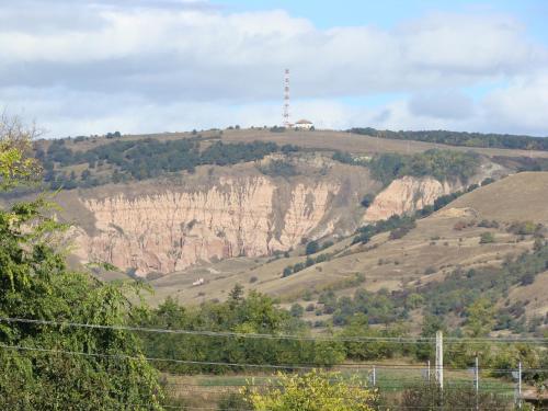 a hill with a radio tower on top of it at Hotel Clasic in Sebeş