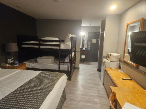 a hotel room with two bunk beds and a television at Travelodge by Wyndham Brandon in Brandon