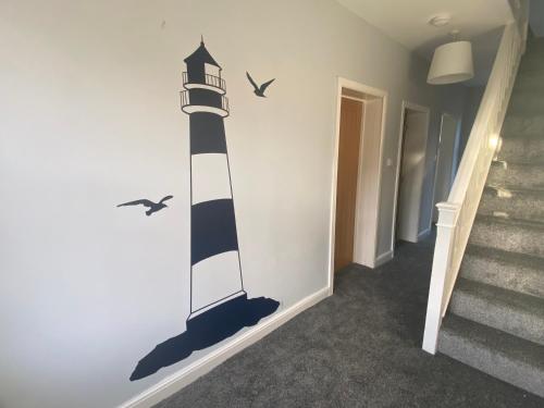 a lighthouse wall sticker with birds on a wall at The Cleveland Way, North Yorkshire in Loftus