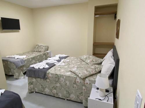 Cama o camas de una habitación en Pousada Canoa dos Anjos suítes