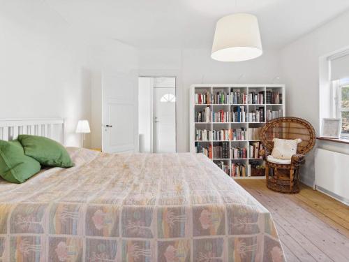 a bedroom with a bed and a book shelf at 7 person holiday home in Tranekær-By Traum in Tranekær
