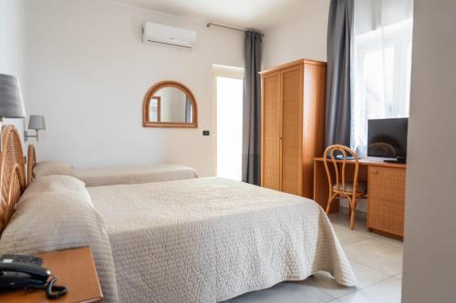 Postel nebo postele na pokoji v ubytování Hotel Corallo