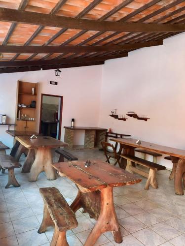 a large room with wooden tables and benches at Pousada JK in Pirenópolis