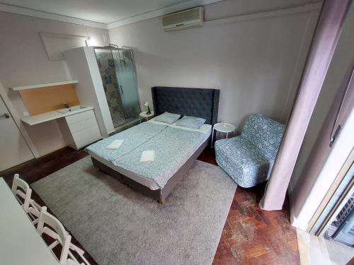 a small bedroom with a bed and a chair at Lisbon`s best at Campo Pequeno in Lisbon