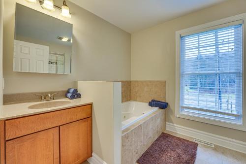 a bathroom with a tub and a sink and a bath tub at Ellicottville Townhome with Hot Tub about 2 Mi to Skiing in Ellicottville