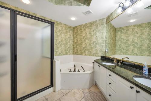 a bathroom with a tub and a sink and a shower at St. Simons Grand # 307 in Saint Simons Island