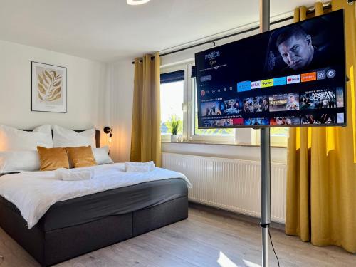 Schlafzimmer mit einem Bett und einem Flachbild-TV in der Unterkunft Design Apartment, Küche, Smart-TV, WLAN in Essen