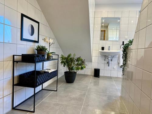 baño con lavabo y pared de azulejos blancos en Design Apartment, Küche, Smart-TV, WLAN, en Essen