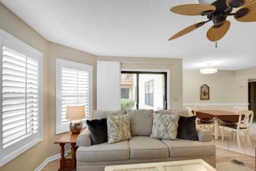 a living room with a couch and a ceiling fan at Harbour Oaks 311 in Saint Simons Island