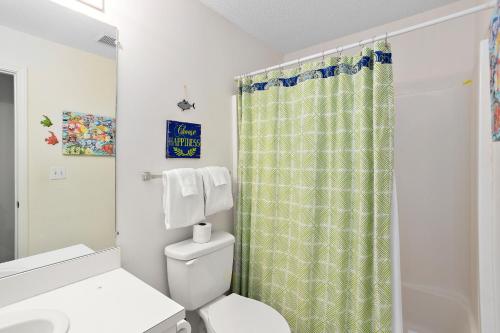 a bathroom with a toilet and a shower curtain at Harbour Oaks 418 in Saint Simons Island