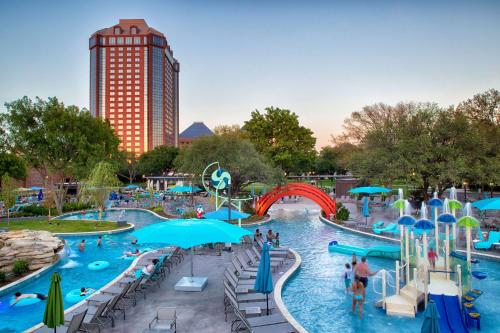 a pool at a water park with people in it at Hilton Anatole in Dallas