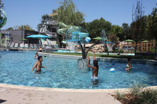 a group of children playing basketball in a swimming pool at Hilton Anatole in Dallas