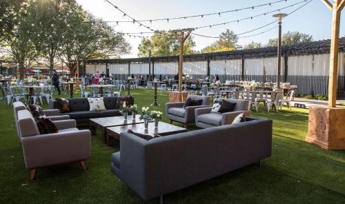 a group of couches and tables with tables and chairs at Hilton Anatole in Dallas