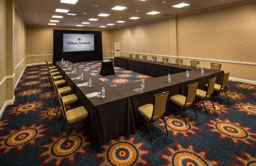 a large conference room with a long table and chairs at Hilton Anatole in Dallas