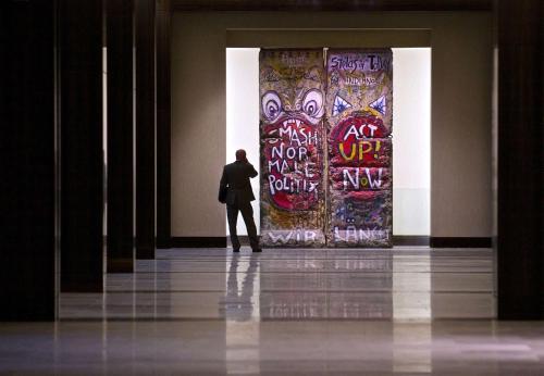 a man standing in front of a wall with a poster at Hilton Anatole in Dallas