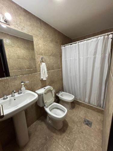 a bathroom with a toilet and a sink at Consorcio San Ignacio in San Juan